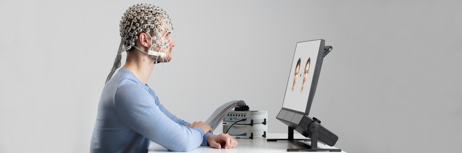 A man using EEG cap looking at Tobii Pro Spectrum