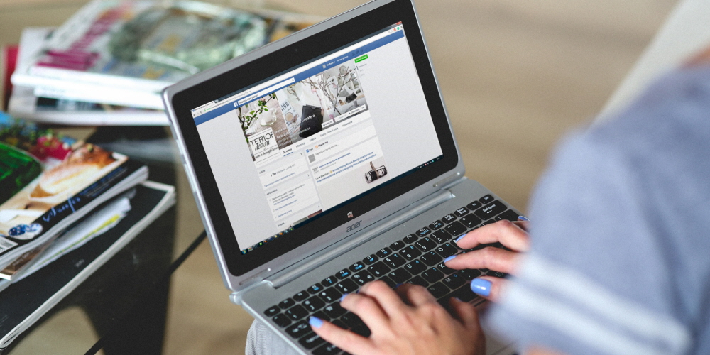 A woman navigating through a website on a laptop.