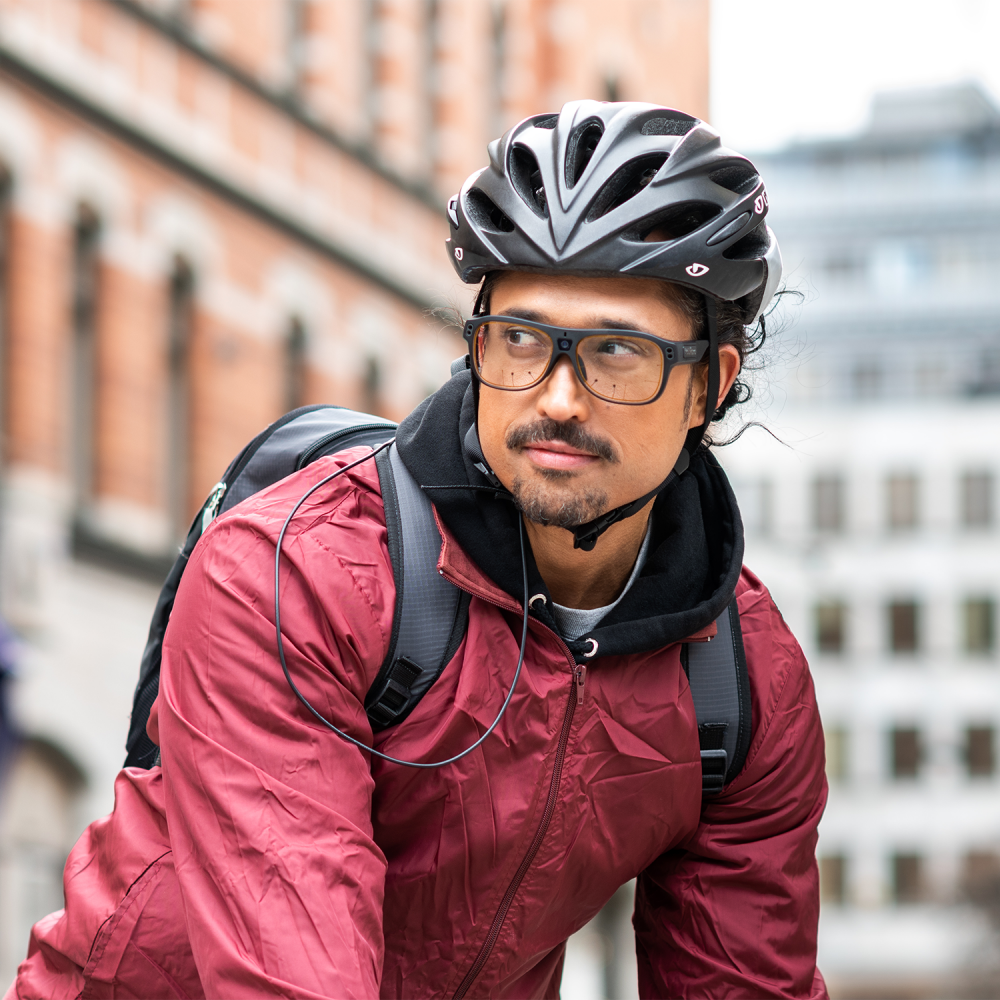 A man biking wearing Tobii Pro Glasses 3 and a helmet