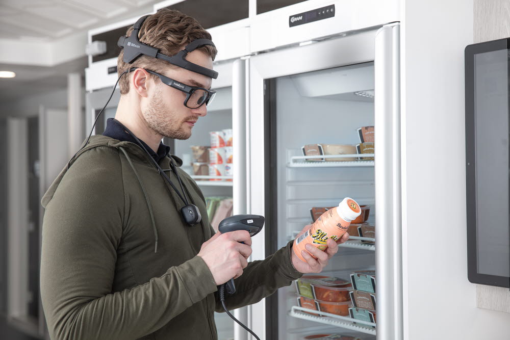 A person using Tobii Pro Glasses 3 and Bitbrain Diadem to look at grocery items