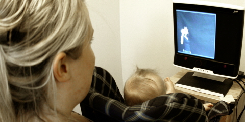 An infant in front of a Tobii ProT120 Eye Tracker  at the Babylab at Uppsala University.